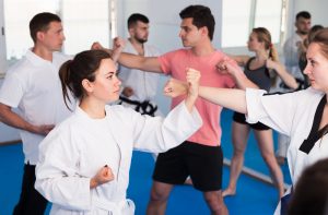 Woman blocking a punch in a Martial Arts Class